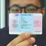 photo of client holding a sample residence card