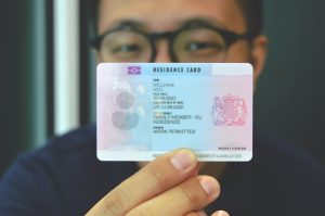 blurred client holding a sample residence card