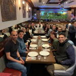 photo of sixteen members of the GAUK and Good Accounts UK teams sitting at the Al Basha restaurant for the 2021 Christmas Dinner with the Director Mr Atef Elmarakby